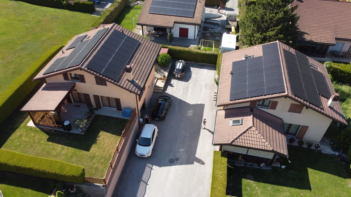 Two houses in Switzerland with solar panels on the roof