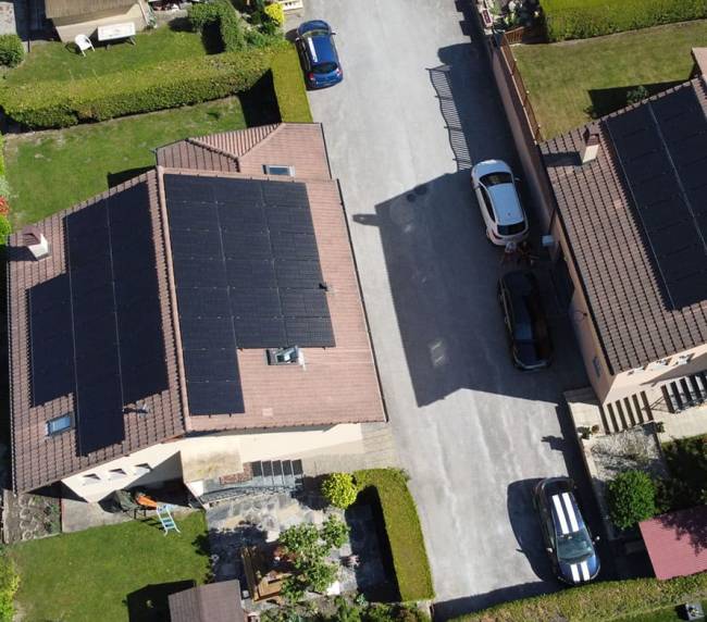 Two houses in Switzerland with solar panels on the roof