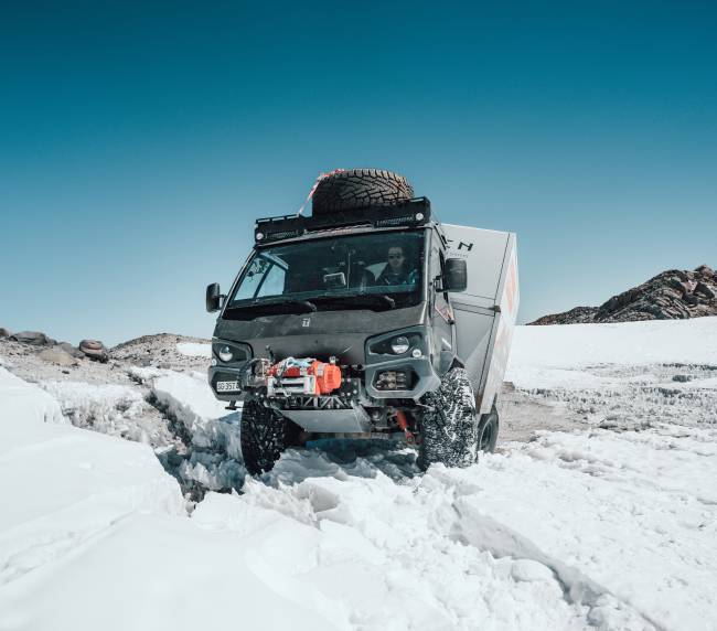 Peak Evolution, truck in the snow at the top of the mountain