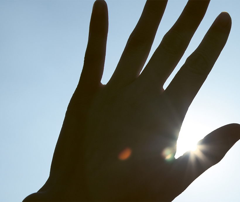 hand covering the sun
