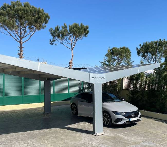 me green solar carport with a car below